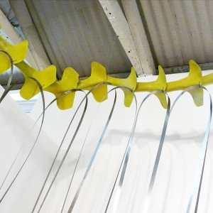 Akirasaurus (Detail View From Below) • Installation, Airplane Parts, Hoist Hooks, Shim Stock, R.A.M.S.E.S Recycled-Assembled-Metal-Surplus-Engineered-Scrap, 108 x 84 x 48-60 inches (274.32 x 213.36 x 121.92 cm) All dimensions slightly variable.